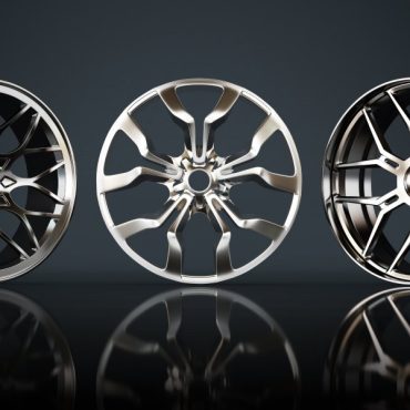 A set of three new car rims of various materials and rim designs displayed vertically against a black background.